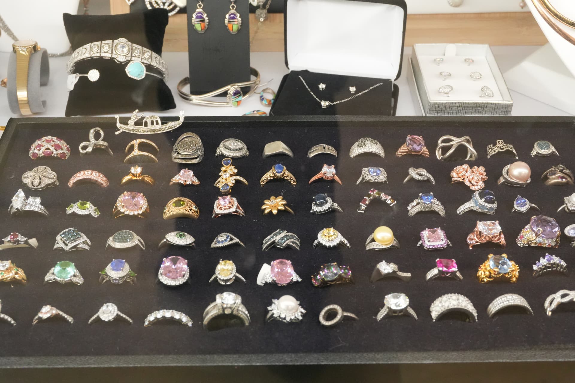 A long tray of sterling silver and gemstone rings in the shop