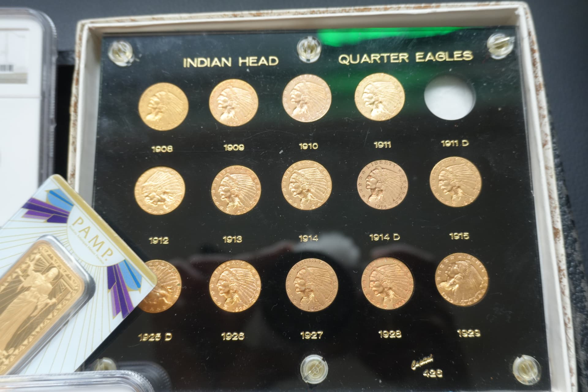 Complete set of Indian Head gold quarter eagles in a display case