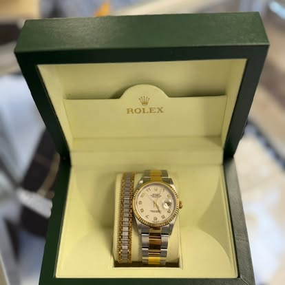 Two-tone Rolex watch in an open Rolex box on the counter