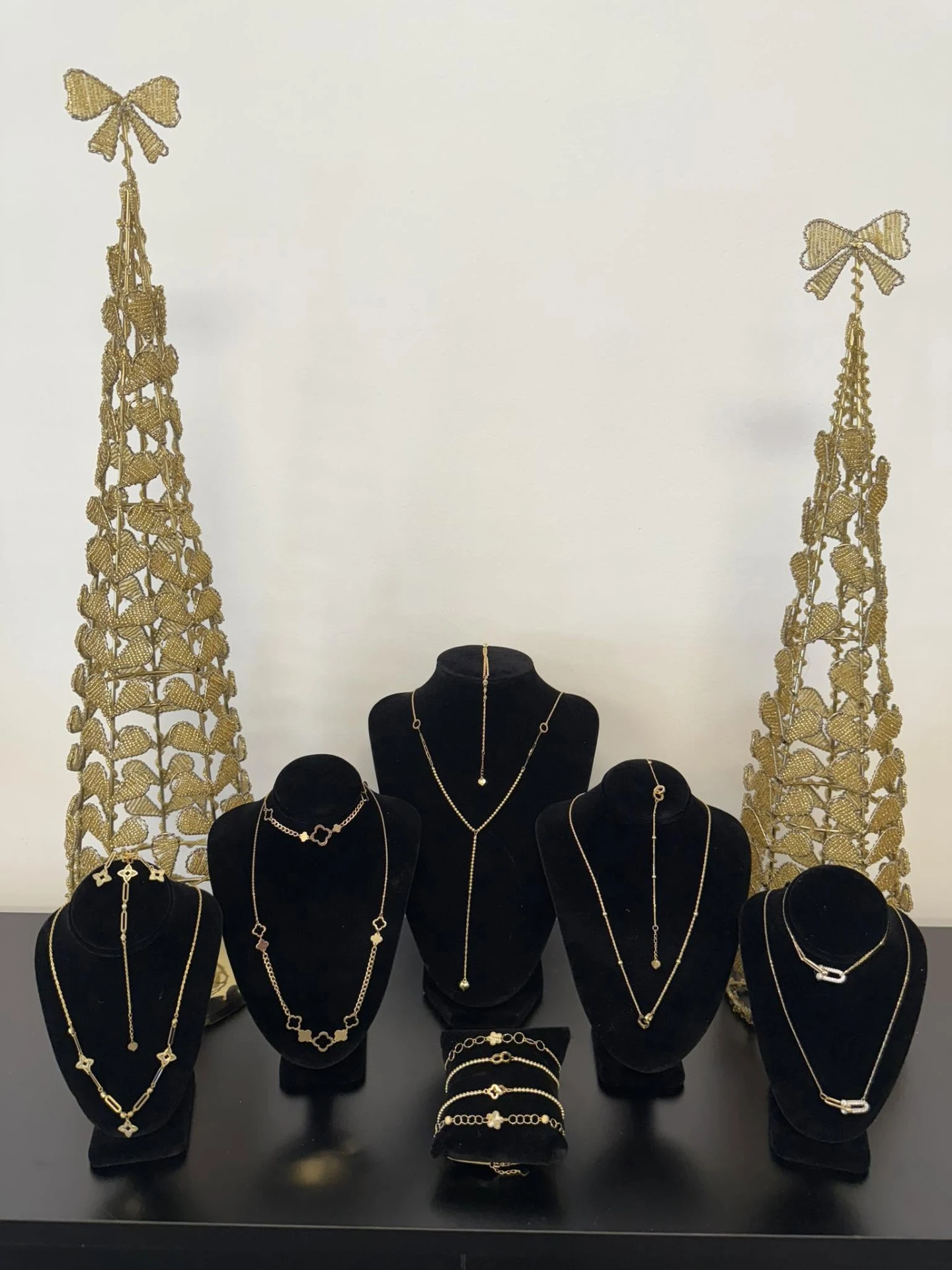 Gold necklaces and bracelets on velvet busts in the shop